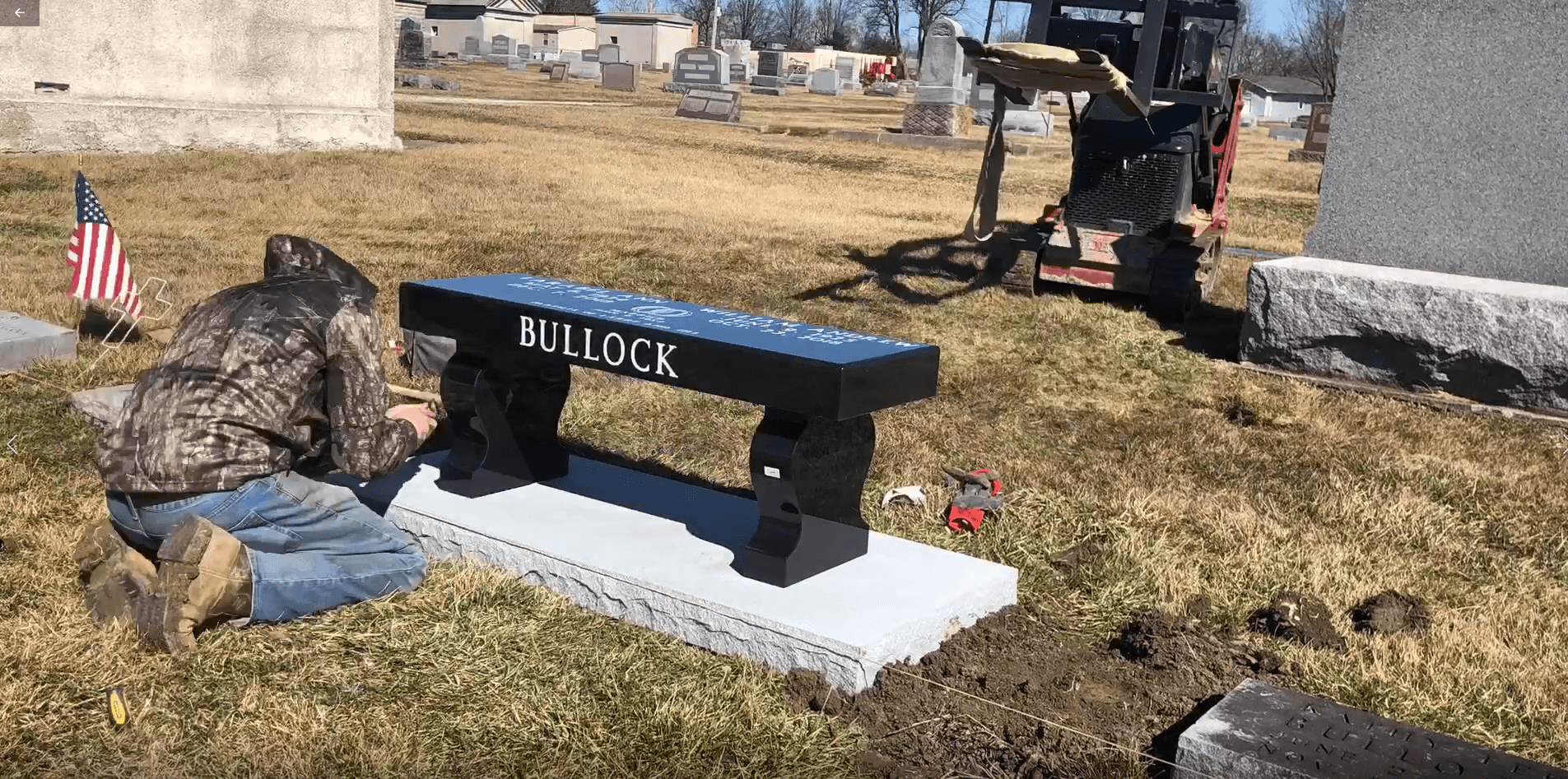 work crew member installing a bench monument